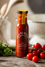 A bottle of Isle of Wight, Classic Tomato Ketchup with tomatoes and parsley.