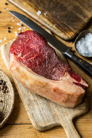 A raw, grass fed, beef sirloin sharing steak ready to be seasoned.