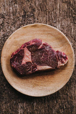 Raw 100% Grass Fed Ribeye Steak on Wooden Cutting Board Ready to Sear